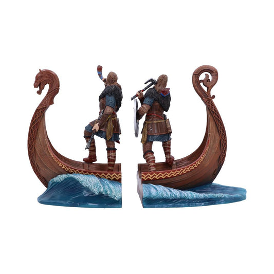 Two Viking figurines stand on a longship's dragon-headed prow, holding axes and shields, displayed as bookends. The ship parts waves on a blue sea, set against a white background.