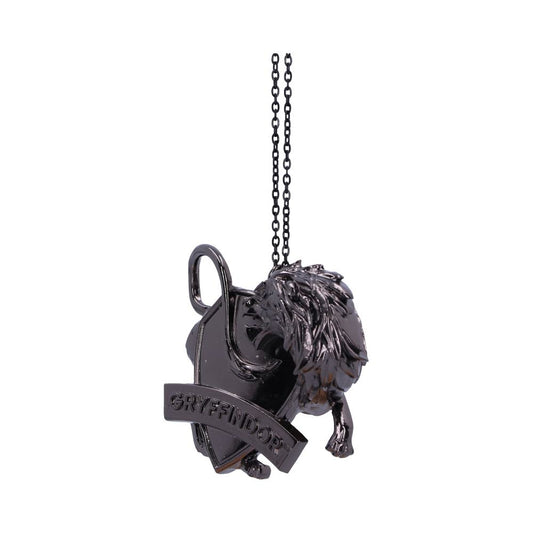 Ornate black pendant featuring a lion’s head and a shield, adorned with a banner reading “GRYFFINDOR,” hangs from a chain, set against a plain white background.