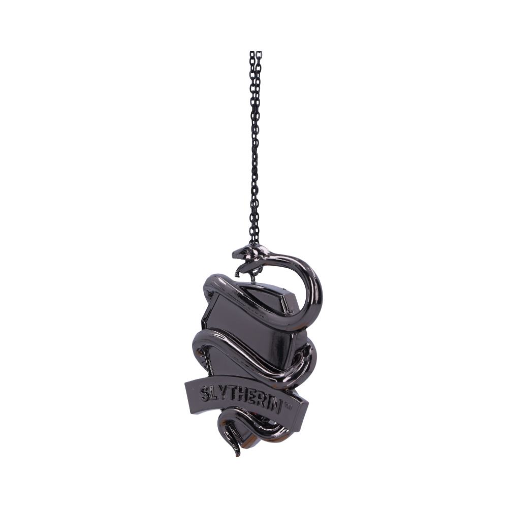 A metallic Slytherin-themed pendant features a coiled snake around a shield, hanging from a chain. The word "SLYTHERIN™" is prominently displayed on a banner at the bottom.