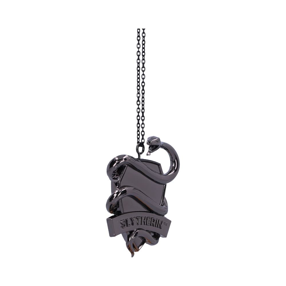 A metallic pendant shaped like a shield features a snake image, the word "SLYTHERIN," and hangs from a thin chain against a plain white background.