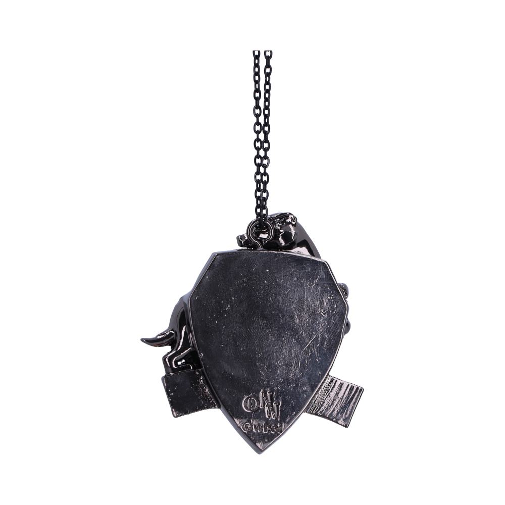 A dark metallic shield-shaped pendant hangs from a chain, featuring animal figures and engraved text: "ON Gucci." The background is plain, enhancing the pendant's details.