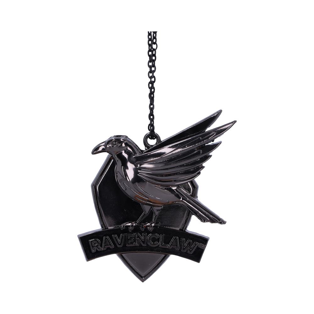 A silver pendant features a raven perched on a shield with "RAVENCLAW" inscribed below, hanging from a chain against a white background.