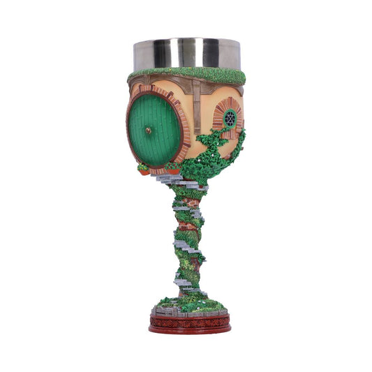 A decorative goblet features a Hobbit house design, with a round green door, round windows, and detailed stone steps wrapped in greenery, on a detailed base, set against a plain background.