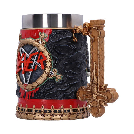 A detailed mug features the word "Slayer" in red on a shield with skulls, engravings, and a prominent, ornate cross-shaped handle, set against a textured black background.