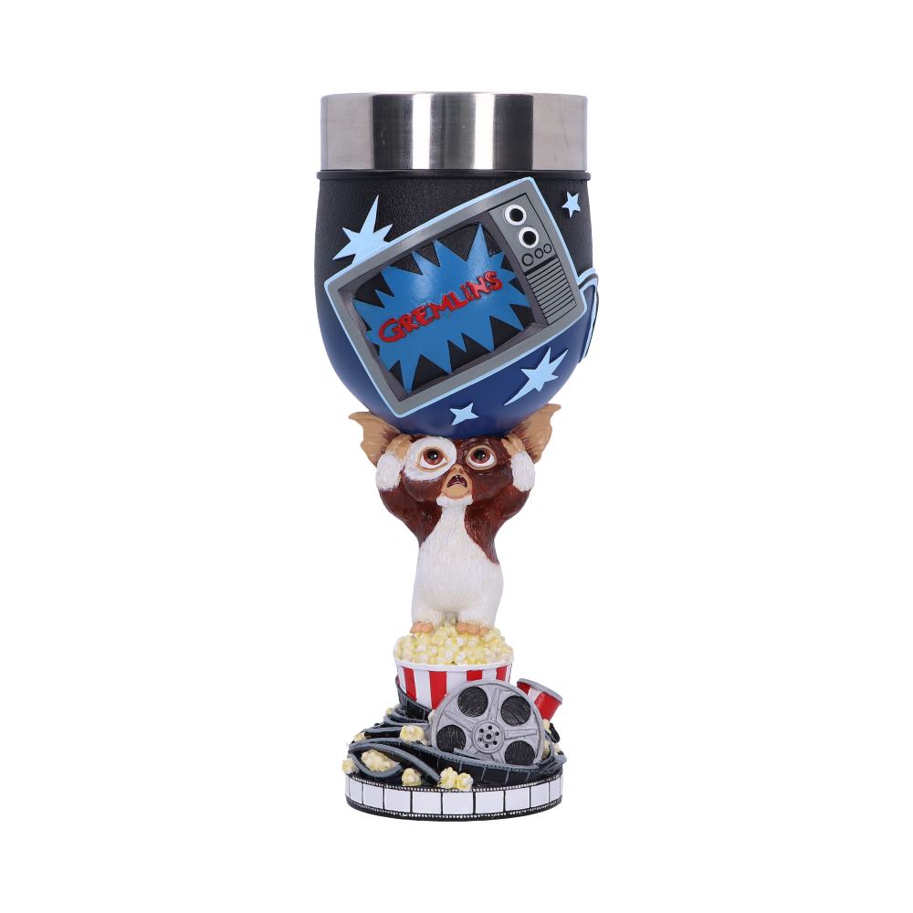 A decorative cup features a creature holding a bowl with a vintage TV reading "GREMLINS." The base has popcorn, film reels, and a strip of film, creating a cinematic theme.