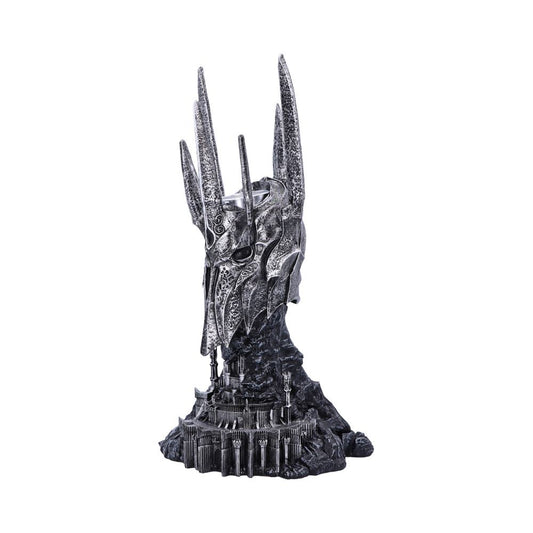 A detailed, ornate helmet sculpture stands on a base designed as a fortress, featuring towering spires and intricate patterns, set against a plain white background.