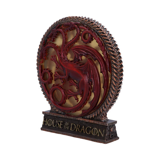 A detailed red dragon emblem in a circular frame stands on a pedestal. Text on the base reads "HOUSE OF THE DRAGON," surrounded by a textured border, isolated on a white background.