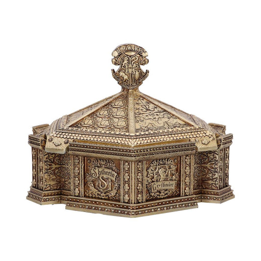 A golden, ornate box features intricate carvings with "Hogwarts," "Slytherin," and "Gryffindor" text. The lid is pyramid-shaped with decorative patterns and a prominent emblem on top.