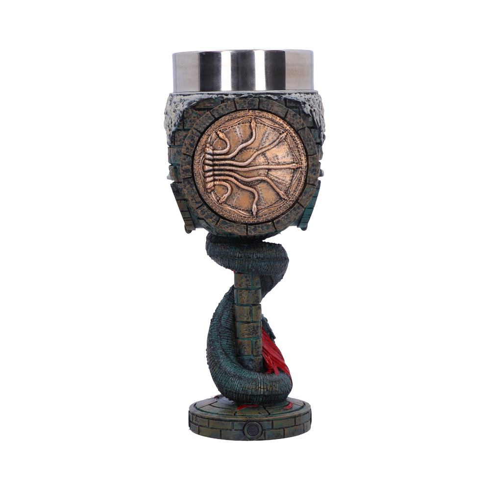 A goblet with a metallic cup top, intricate embossed designs, and a sculpted serpent coiling around its stone-textured stem, stands prominently against a plain background.