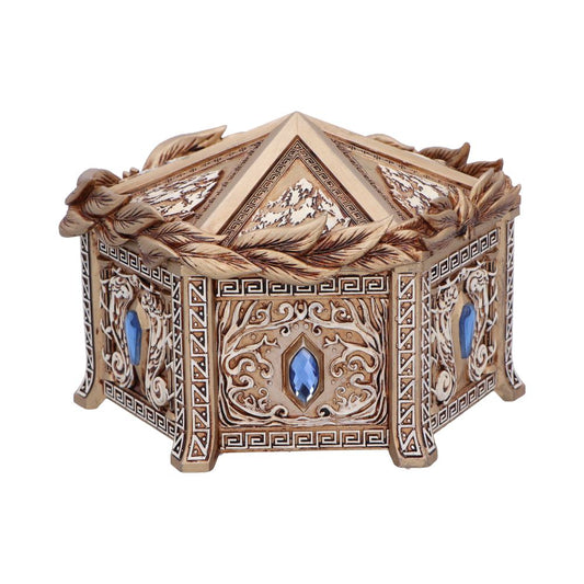 An ornate hexagonal box, decorated with carvings and blue gems, sits on a white background.