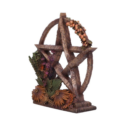 A pentacle stands on a base, adorned with sculpted autumnal flora. The pentacle is wood-textured, brown, and encircled. The context is a white background.
