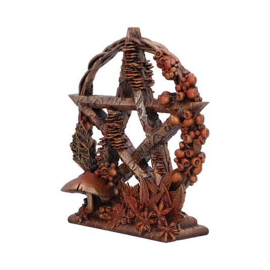 A pentacle-shaped figurine, adorned with autumnal foliage and berries, sits on a base. The pentacle is crafted from wood-like material and is encircled by a vine.