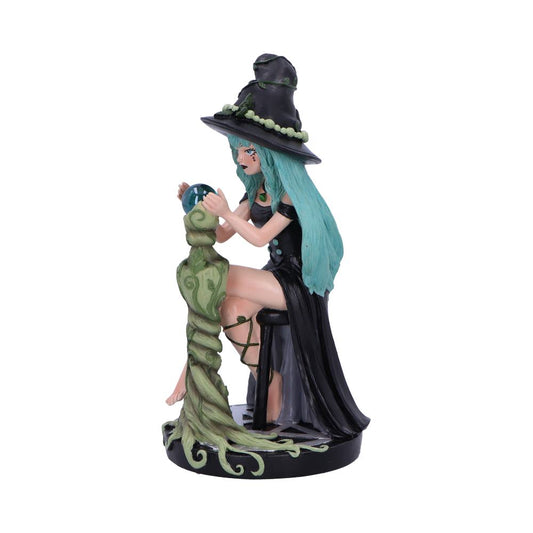 A figurine of a witch with teal hair, wearing a black dress and hat, gazes into a crystal ball atop a swirling, vine-like pedestal.