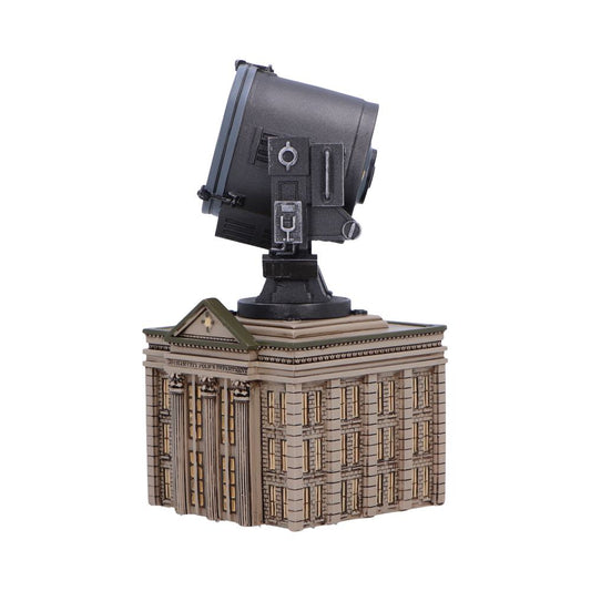 A large black spotlight sits atop a detailed miniature building model labeled "GOTHAM CITY POLICE DEPARTMENT," suggesting an iconic scene setup from a fictional universe.