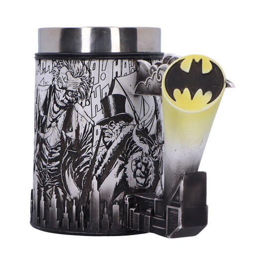 A cylindrical mug features comic-style illustrations of iconic characters with "HA!" text. A 3D Bat-Signal projector protrudes from the side, set against a backdrop of city skyscrapers.