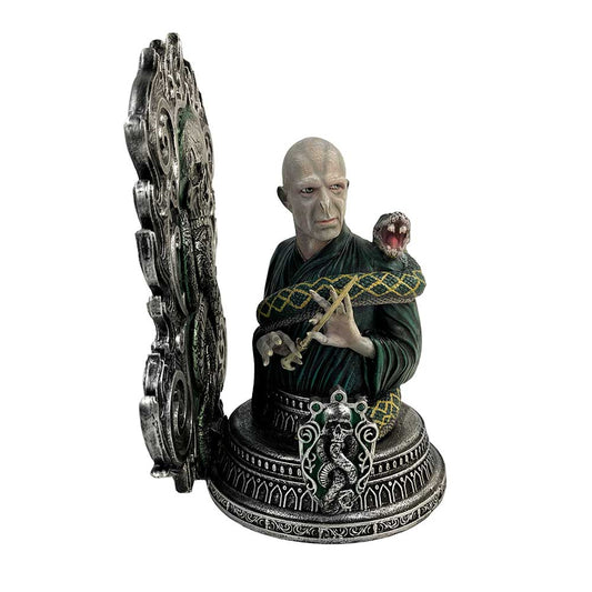 A detailed bust depicts a bald, solemn figure holding a wand, with a snake winding around them. The ornate base features a green and silver emblem.