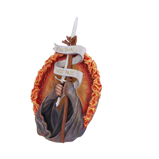 A figure grasps a sword with two hands, wrapped in banners reading "YOU SHALL NOT PASS," set against a fiery, engraved circular backdrop.