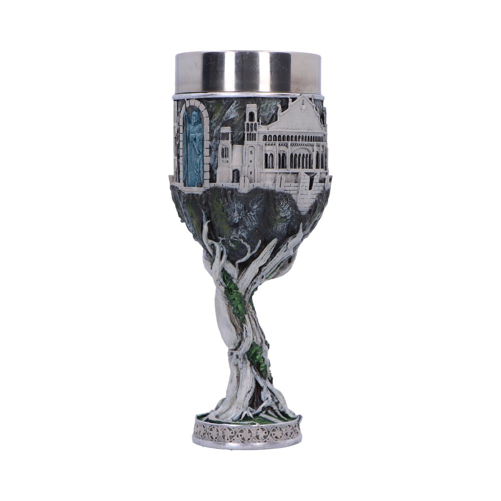 A decorative chalice features a castle and tree design on the stem and base, with a silver-toned rim, set against a plain white background.