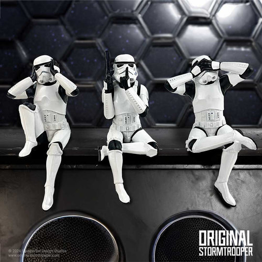 Three Stormtrooper figures are seated in "see no evil, hear no evil, speak no evil" poses on a ledge. The background features a hexagonal pattern. Text: “ORIGINAL STORMTROOPER”.