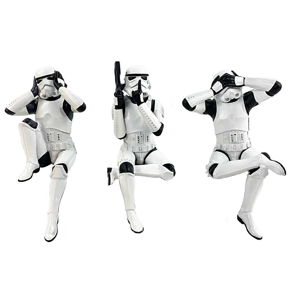 Three stormtrooper figurines perform "see no evil, speak no evil, hear no evil" actions, kneeling with expressive hand gestures, set against a plain white background.