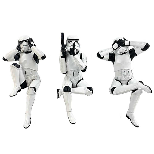 Three stormtrooper figurines perform "see no evil, speak no evil, hear no evil" actions, kneeling with expressive hand gestures, set against a plain white background.