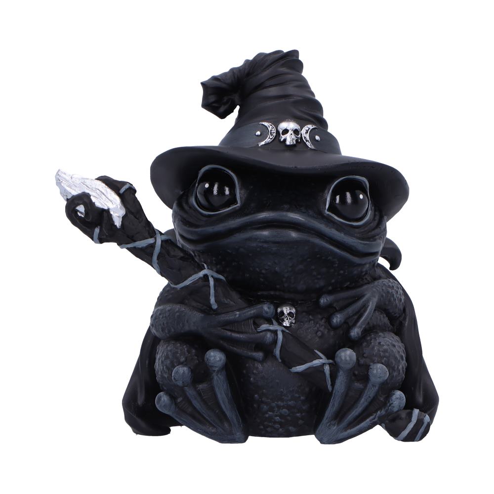 A black frog figurine, wearing a witch's hat and holding a staff, sits against a white background.