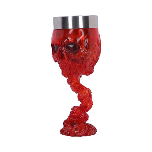 A red skull-shaped goblet, with a metallic rim, sits on a white background. The goblet's stem is sculpted into a flowing, swirling design.