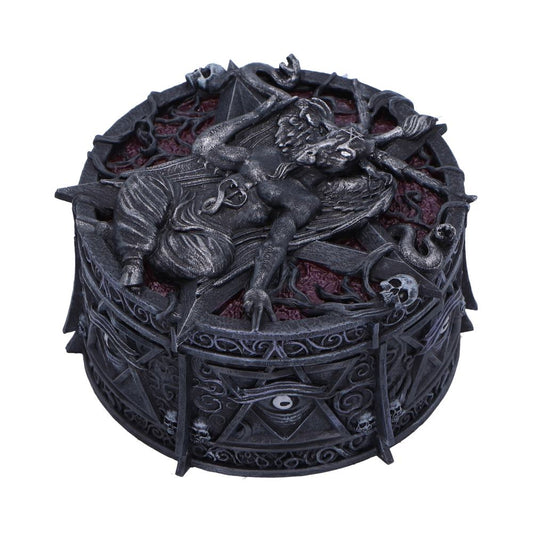 An intricately carved, cylindrical box features a mythical creature in repose on its lid, surrounded by ornate patterns and skull motifs, creating a dark, mystical ambiance.