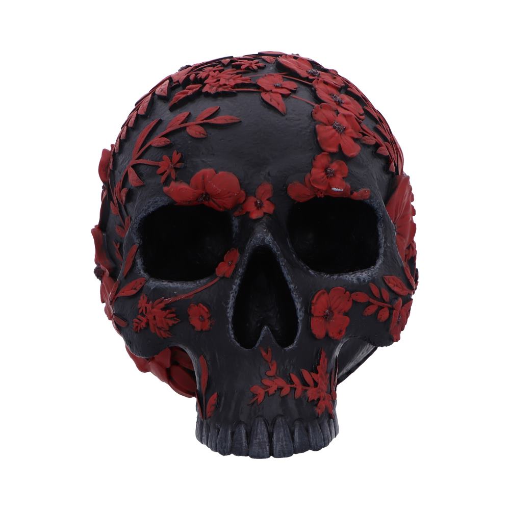A black skull is intricately adorned with red floral designs, creating a striking contrast. The flowers and leaves cover the surface, adding an artistic element to the otherwise somber object.