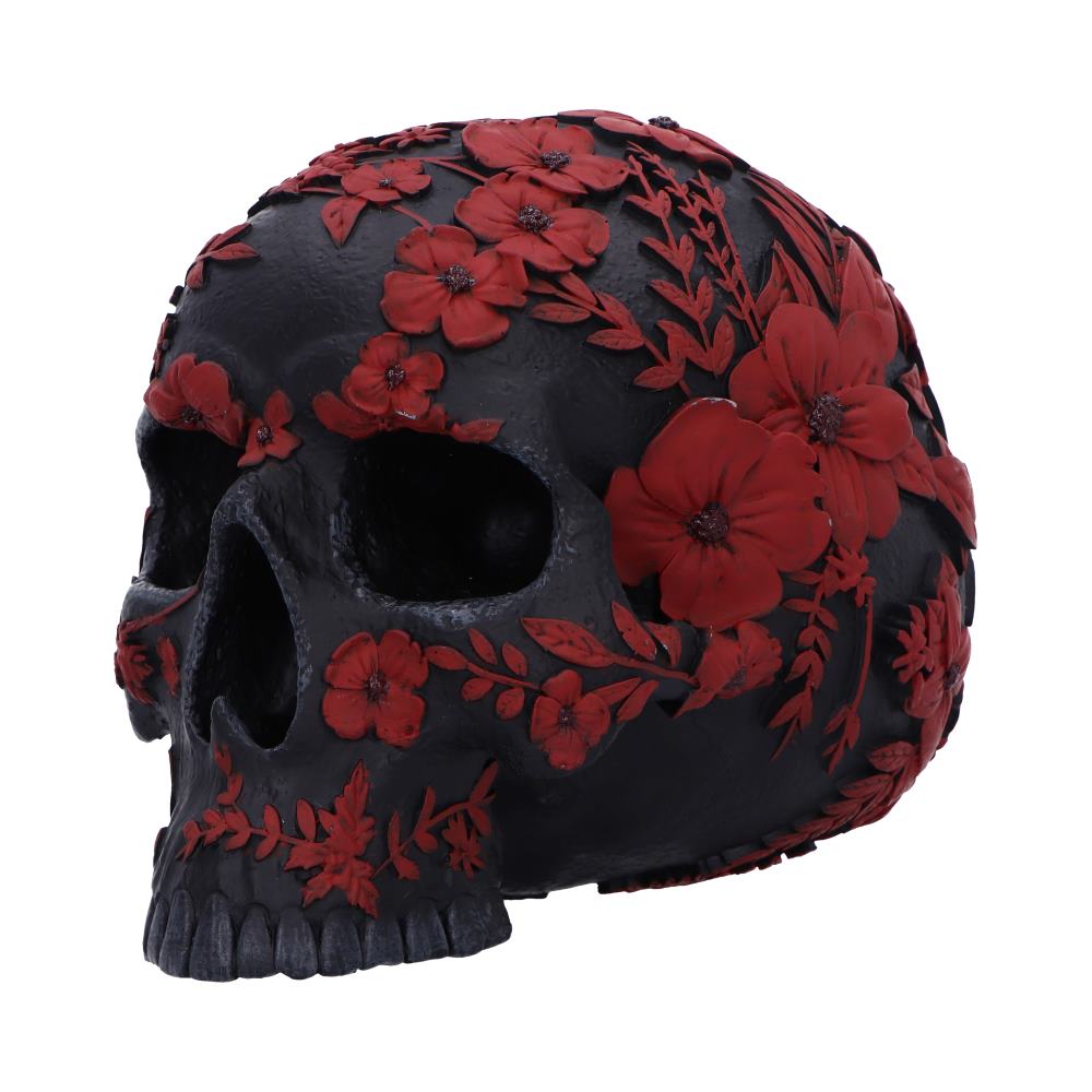 A black skull adorned with intricate red flowers and leaves, sits prominently. The floral patterns cover the entire surface, adding a decorative and vibrant touch to the dark object.