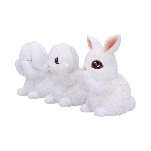 Three white rabbit figurines sit side by side, each covering their eyes, ears, or mouth, symbolizing "see no evil, hear no evil, speak no evil" on a plain background.