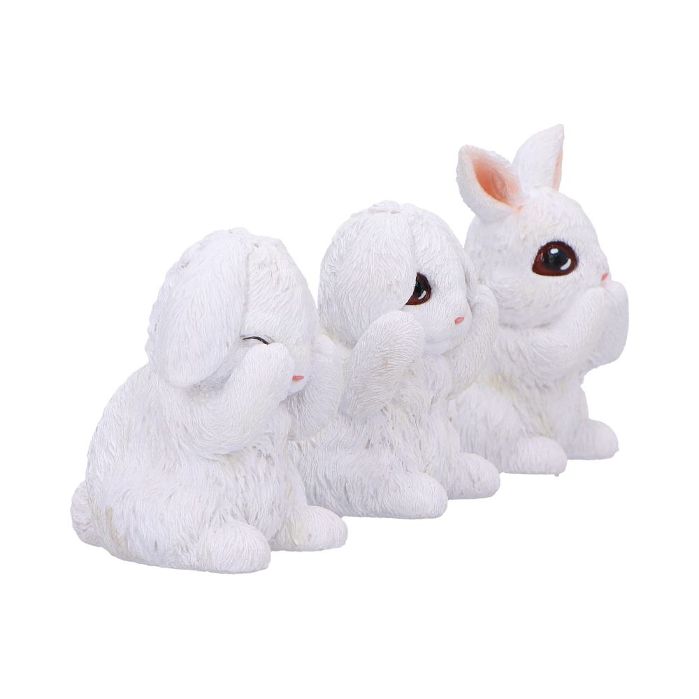 Three white rabbit figurines sit in a row, each covering their eyes, ears, and mouth, symbolizing "See no evil, hear no evil, speak no evil," on a plain white background.