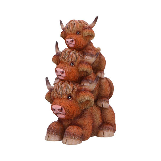 Three small, brown Highland cow figurines are stacked vertically. Each cow has distinctive long horns and fluffy hair. The background is plain and white, enhancing the focus on the figures.