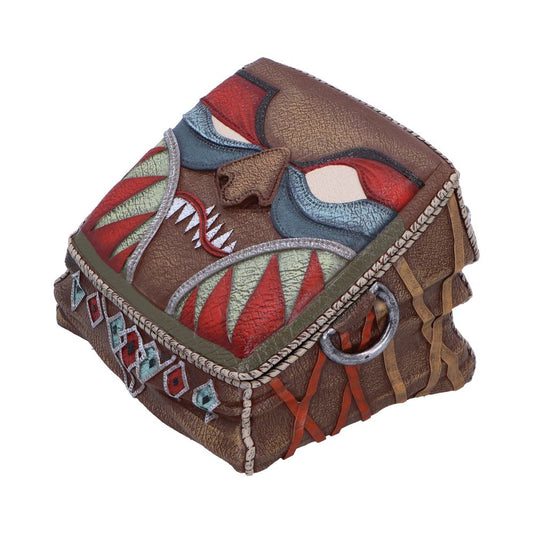 A small, textured, brown chest with a tribal mask design featuring colorful geometric patterns and bold facial features, sits in a plain white background.