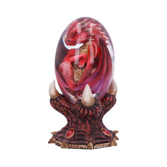 A red dragon sits curled inside a transparent egg, supported by a clawed base with red gemstones, resembling a mystical ornament.