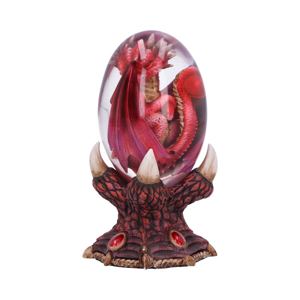 A red dragon curls inside a clear, oval-shaped egg, resting on a clawed, textured base resembling scaled skin with red gemstone accents.