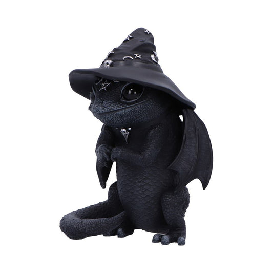 A black dragon figurine wearing a witch hat adorned with stars and crescent moons sits with folded wings in a playfully whimsical posture, in front of a plain white background.
