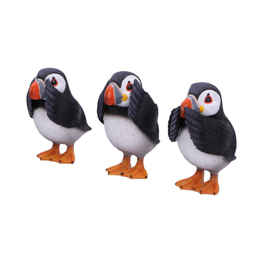 Three cartoon-style puffin sculptures, each covering different parts of their faces with wings, resembling "see no evil, hear no evil, speak no evil," in a plain white setting.