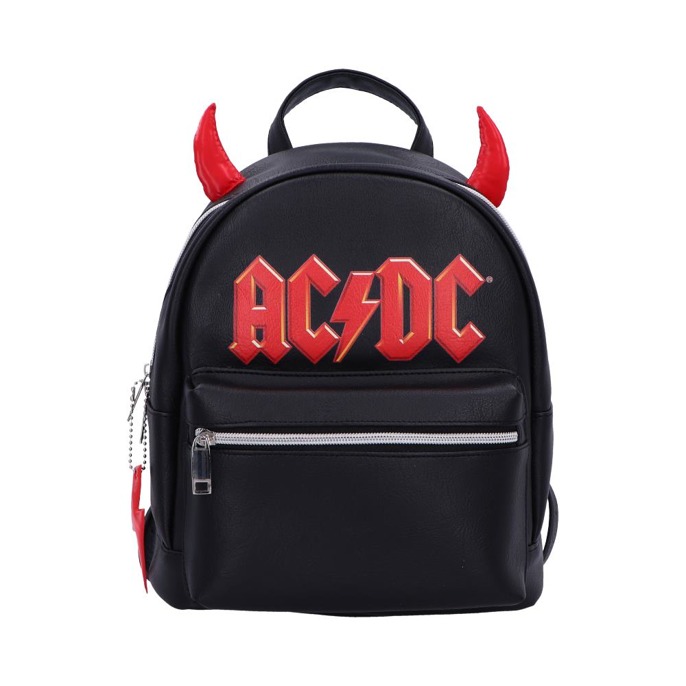 A black backpack displays red "AC/DC" text and features red devil horns attached. It includes a front zipper pocket and appears in a plain, white backdrop.