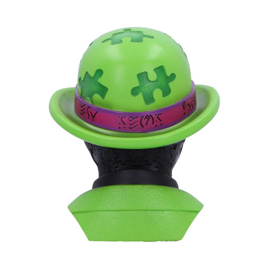 Green puzzle-piece hat with a purple decorative band rests on a black puzzle-textured bust mounted on a green base against a plain white background.