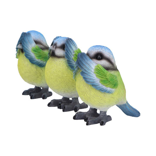 Three small colorful bird figurines stand side by side with wings partially raised showing blue heads, green wings and yellow bodies against a plain white background.