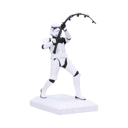 White armored stormtrooper figurine grasping and swinging a curved black cable like weapon overhead while standing in a wide stance on a square white display base against a plain white background.