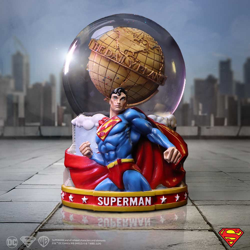 Superman figurine kneels with clenched fist beneath a glass globe labeled THE DAILY PLANET on a city rooftop; base reads SUPERMAN; copyright: SUPERMAN and all related characters and elements © & ™ DC Comics. WB SHIELD: © & ™ WBEI. (s24)
