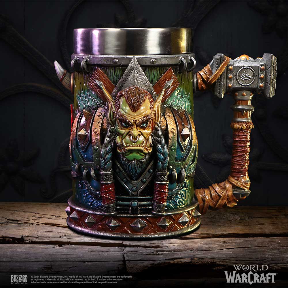 Orc-themed metal tankard features a snarling orc face with braided hair and a hammer-shaped handle, resting on a cracked wooden plank against a dark backdrop; text: "© 2024 Blizzard Entertainment, Inc. World of Warcraft and Blizzard Entertainment are trademarks or registered trademarks of Blizzard Entertainment, Inc. in the U.S. and/or other countries. All other trademarks referenced herein are the properties of their respective owners." BLIZZARD WORLD OF WARCRAFT