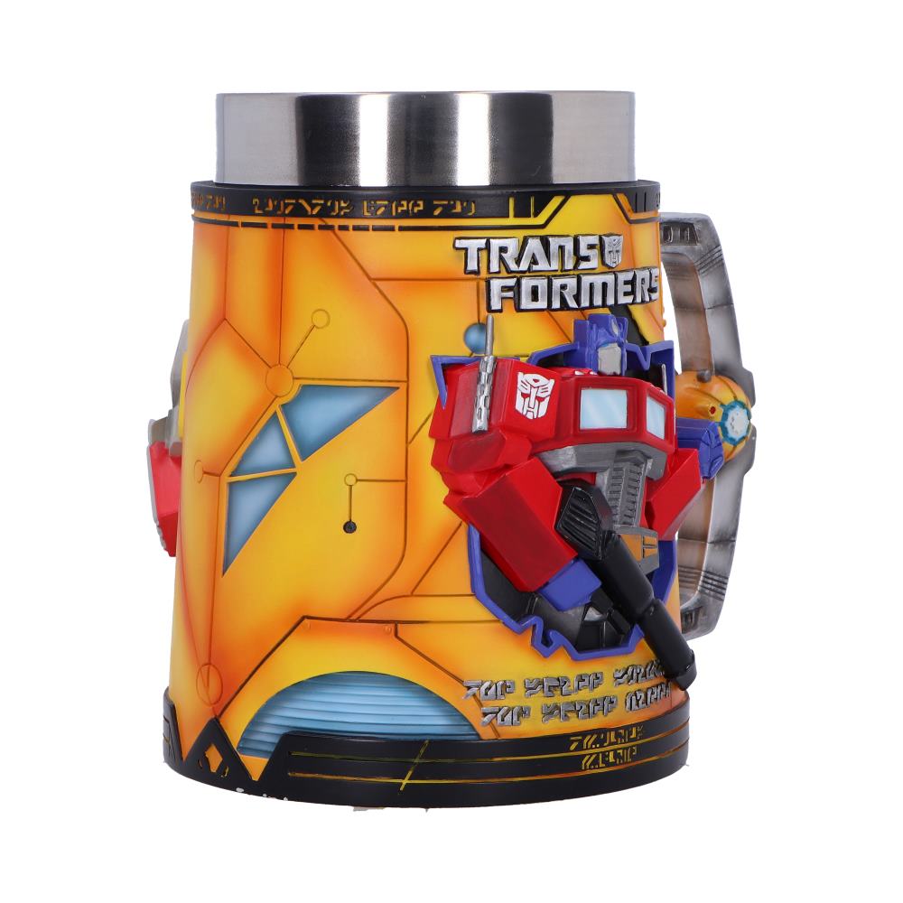 Yellow Transformers-themed mug displays a red Optimus Prime bust attached to its side and a metal rim, sitting on a white background, text: TRANS FORMERS