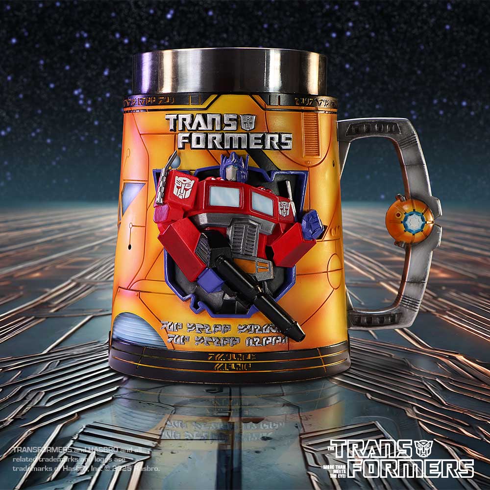 Metallic Transformers mug displays a raised Optimus Prime figure holding a blaster on a reflective circuit-board surface beneath a starry sky; Text: "TRANSFORMERS"; "THE TRANSFORMERS"; "TRANSFORMERS and HASBRO and all related trademarks and logos are trademarks of Hasbro, Inc. © 2025 Hasbro."