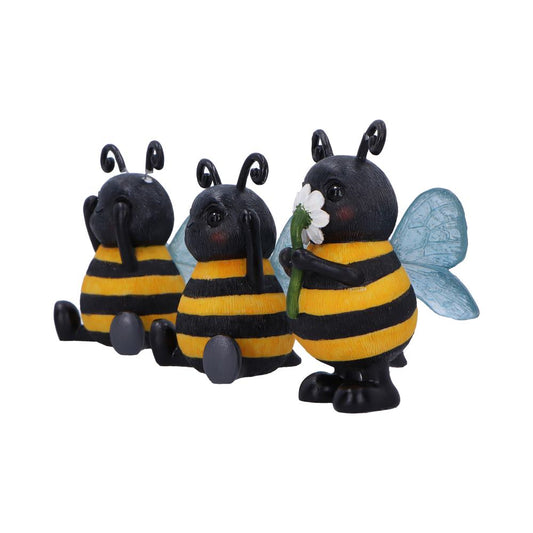 Three bee figurines, one standing and holding a daisy while two sit with their hands to their faces, arranged against a plain white background.