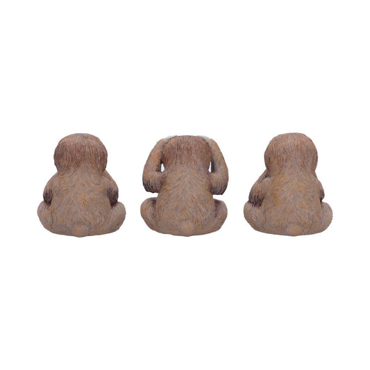 Three small brown furry monkey figurines sit with their backs to the viewer; the center one raises its hands to its head while the others rest at their sides on a plain white background.