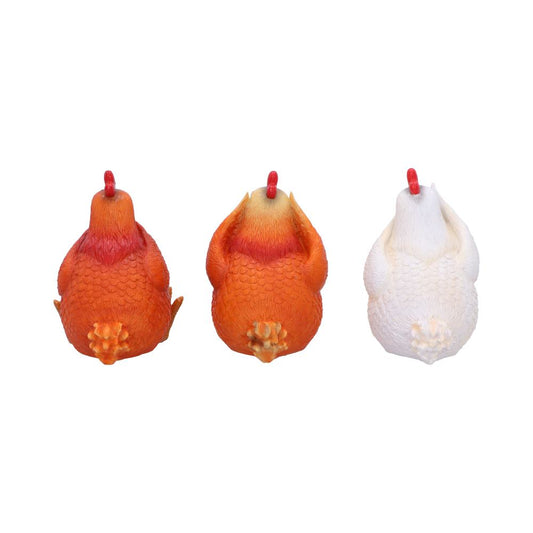 Three toy chickens sit side by side viewed from the rear: two orange and one white with red combs and textured feathers against a plain white background.