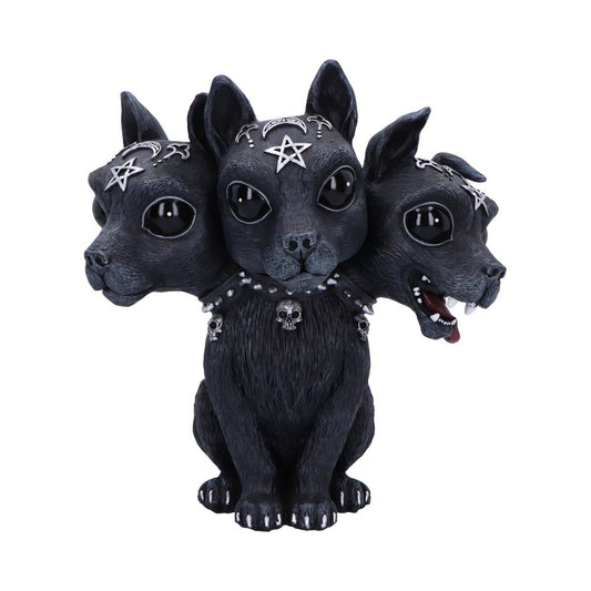 Three-headed black dog sculpture sits facing front with center head neutral and side heads turned, wearing studded skull collar and silver pentagram and crescent ornaments against a plain white background.